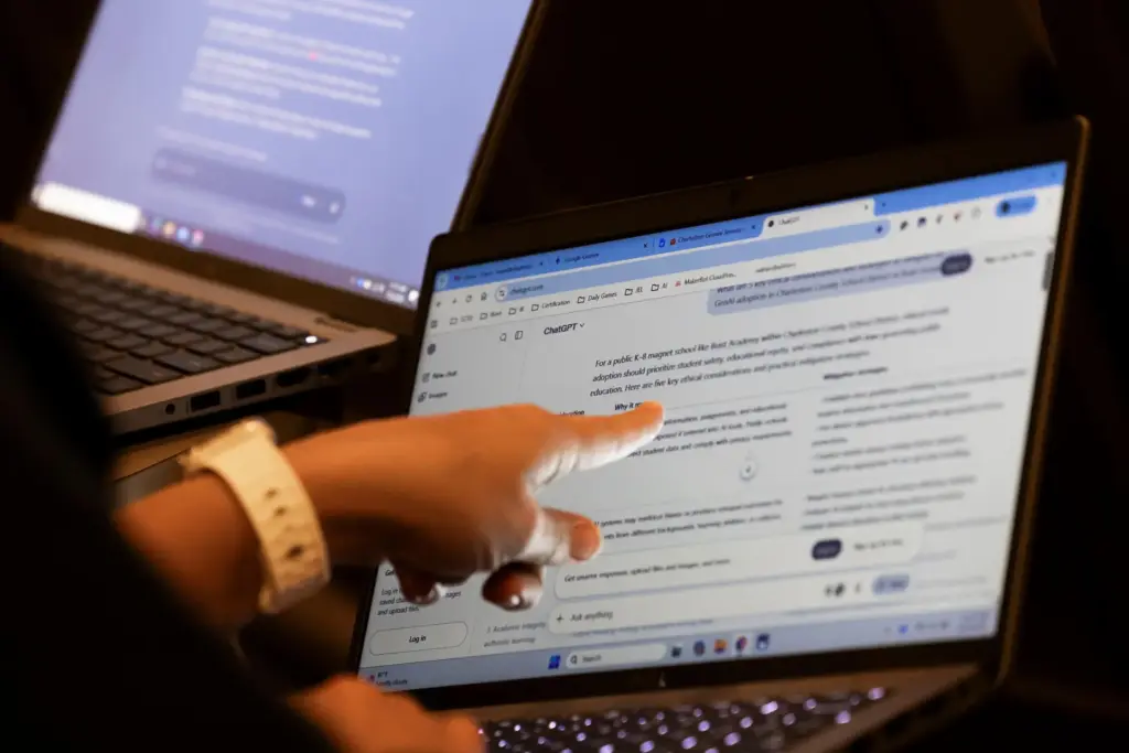 Teachers work with AI on their laptops during the Charleston...