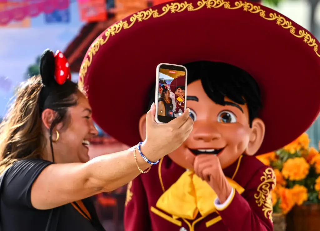 Kyla Kendle takes a selfie with Miguel, from Coco, during...