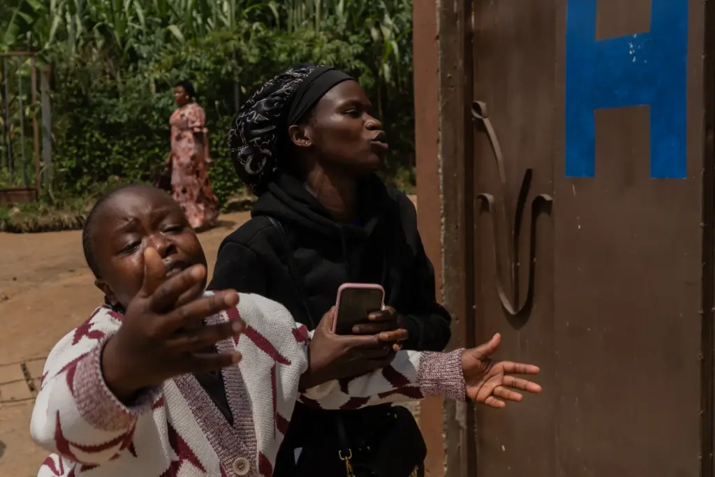 Relatives of AngÃ¨le Muyumba Nsimire react as health workers prepare her body.