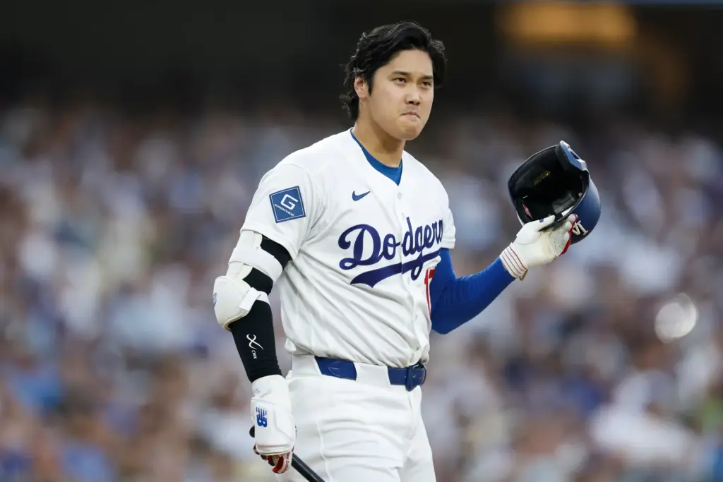 Dodgers star Shohei Ohtani takes off his batting helmet after...