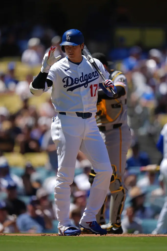 Dodgers’ Shohei Ohtani gestures before batting during the first inning...