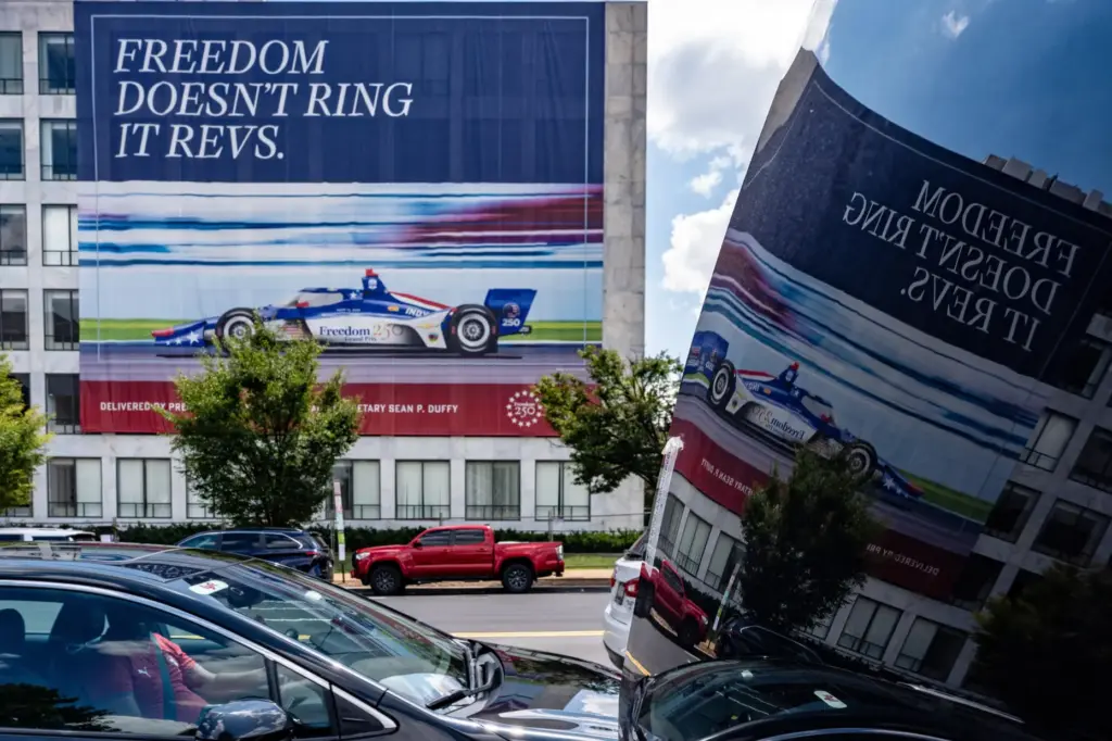 A sign on a building along the route for the upcoming Freedom 250 Grand Prix.