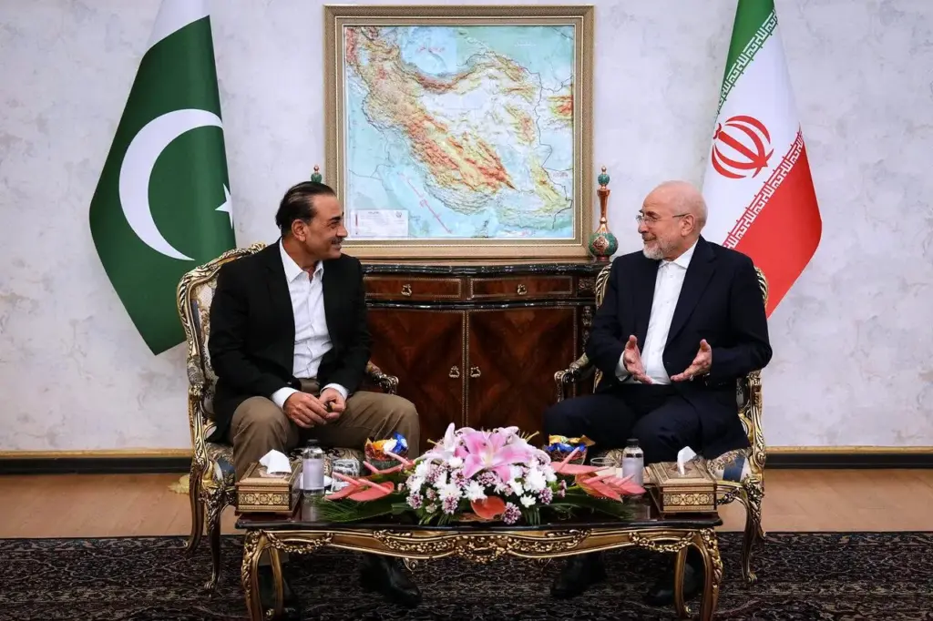 Iran's Parliament Speaker Mohammad Bagher Qalibaf shakes hands with Pakistan's Gen. Asim Munir.