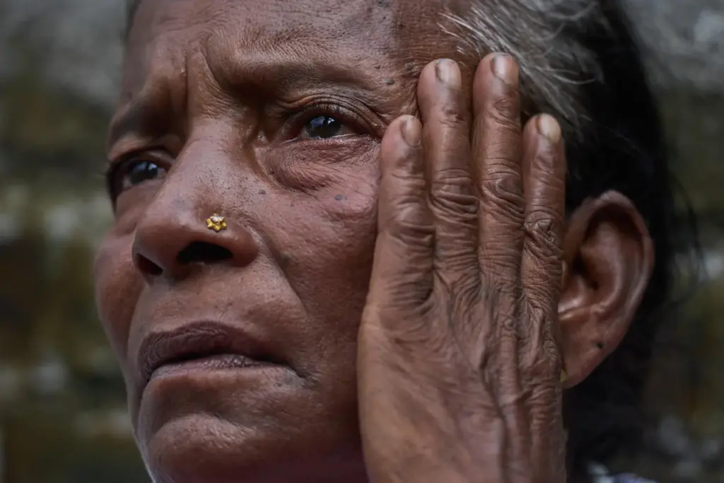Kanchi Nepali, a flash flood survivor, waits to receive relief...