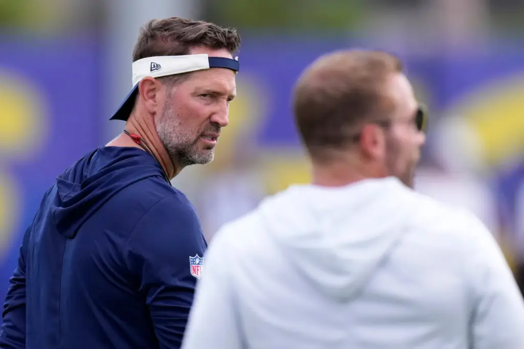 Dallas Cowboys head coach Brian Schottenheimer, left, looks over at...