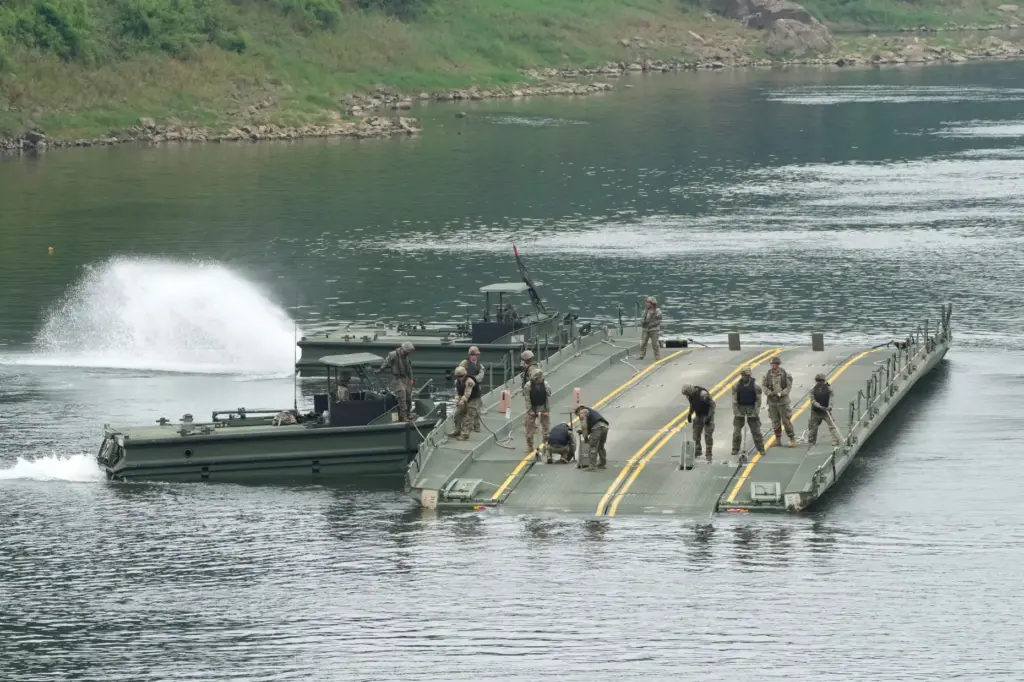U.S. Army soldiers try to dismantle a floating bridge during a training exercise on a Yeoncheon river.