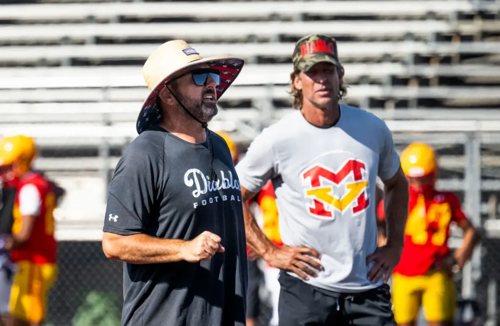 Mission Viejo High School head coach Chad Johnson, left, and...