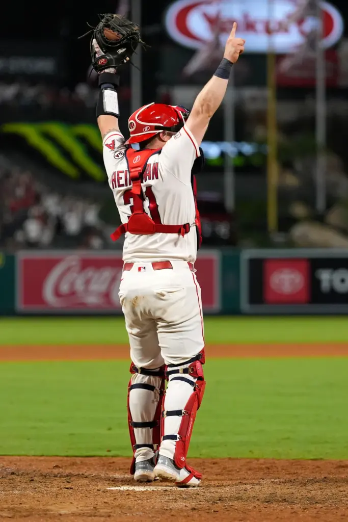 Angels catcher Tyler Heineman celebrates after right fielder Wade Meckler...