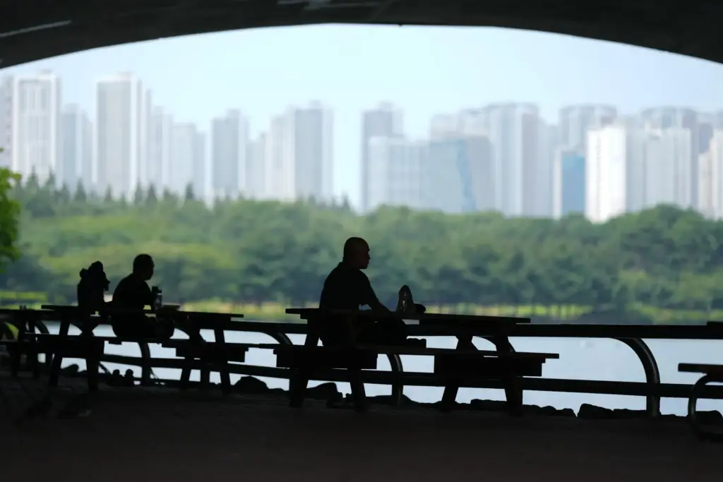 People sit in the shade to avoid the heat in Goyang, South Korea.