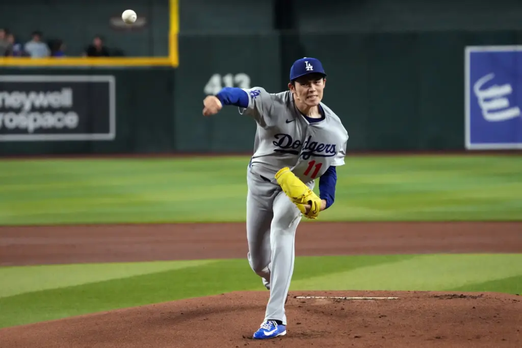Dodgers starting pitcher Roki Sasaki throws to the plate during...