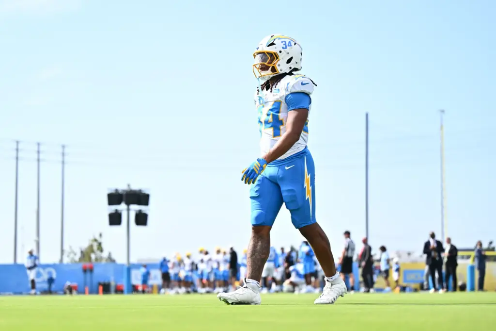 Chargers running back Keaton Mitchell walks on the field during...