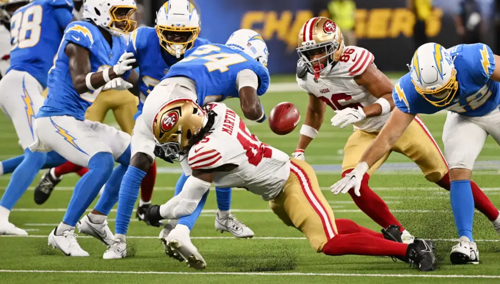 Chargers wide receiver Devonte Ross (24) fumbles the ball while...