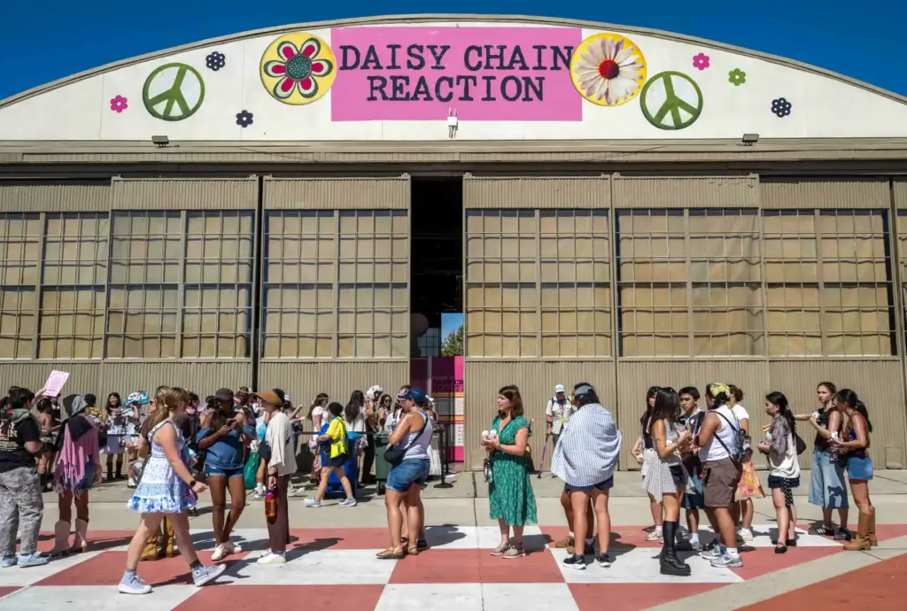 Festivalgoers wait in line to visit the Daisy Chain Reaction...