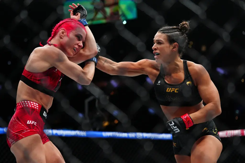 Mackenzie Dern, right, punches Gillian Robertson in a women’s strawweight...