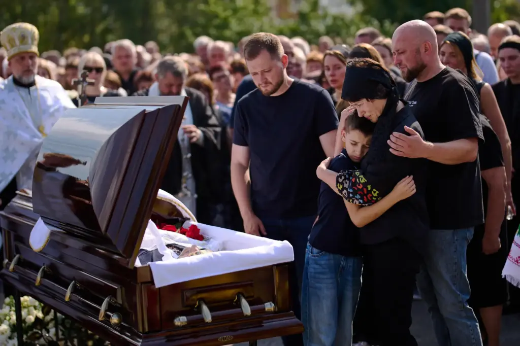 Relatives mourn Taras Didych, head of the Dmytrivska community in...