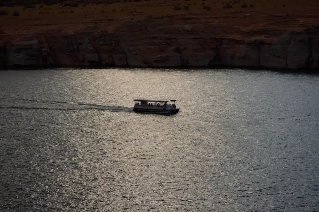 People boat on Lake Powell at the Glen Canyon National Recreation Area.