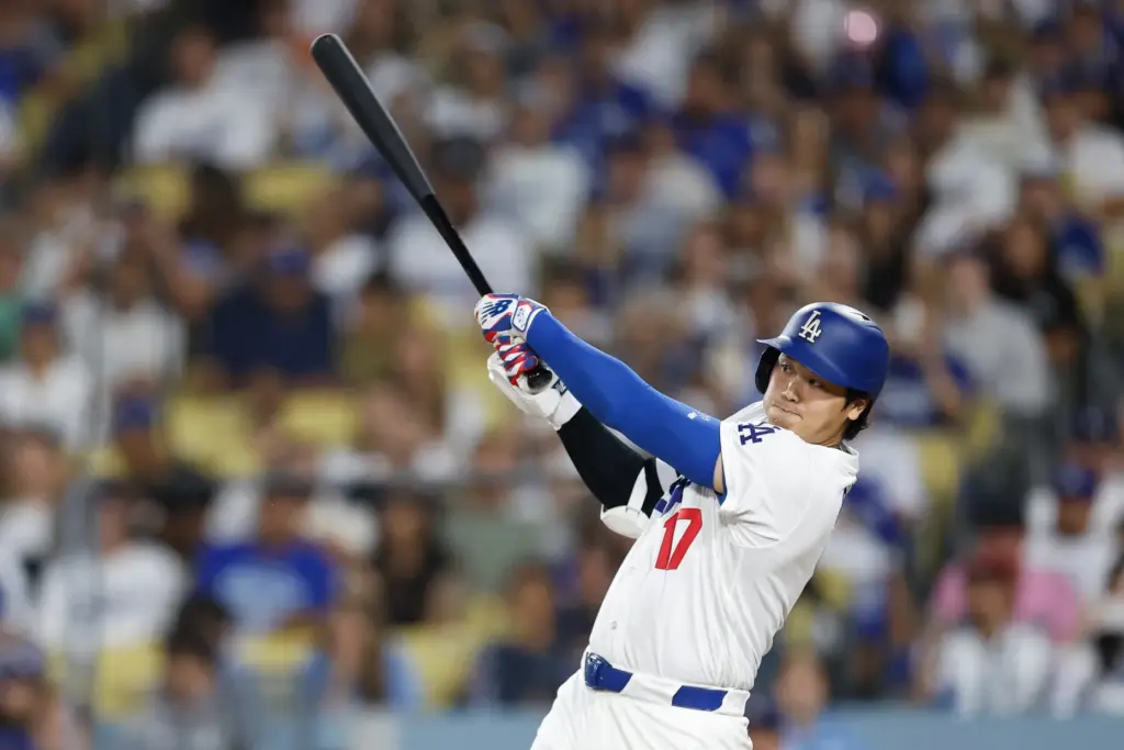 Dodgers star Shohei Ohtani hits a single during the seventh...