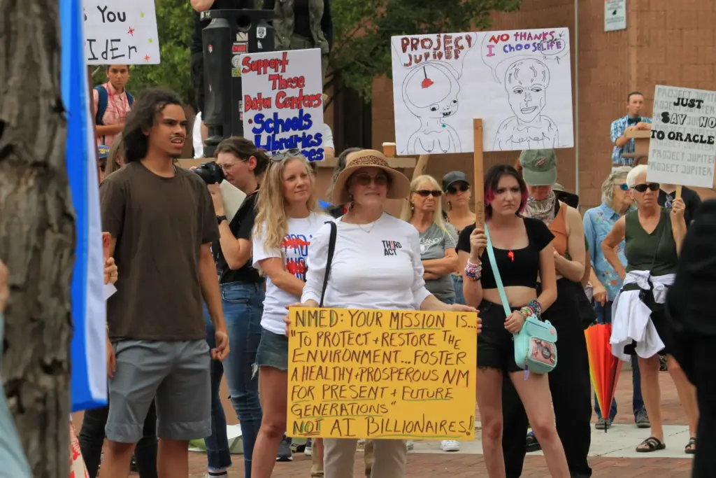 Protesters gather outside a state office to voice opposition to...