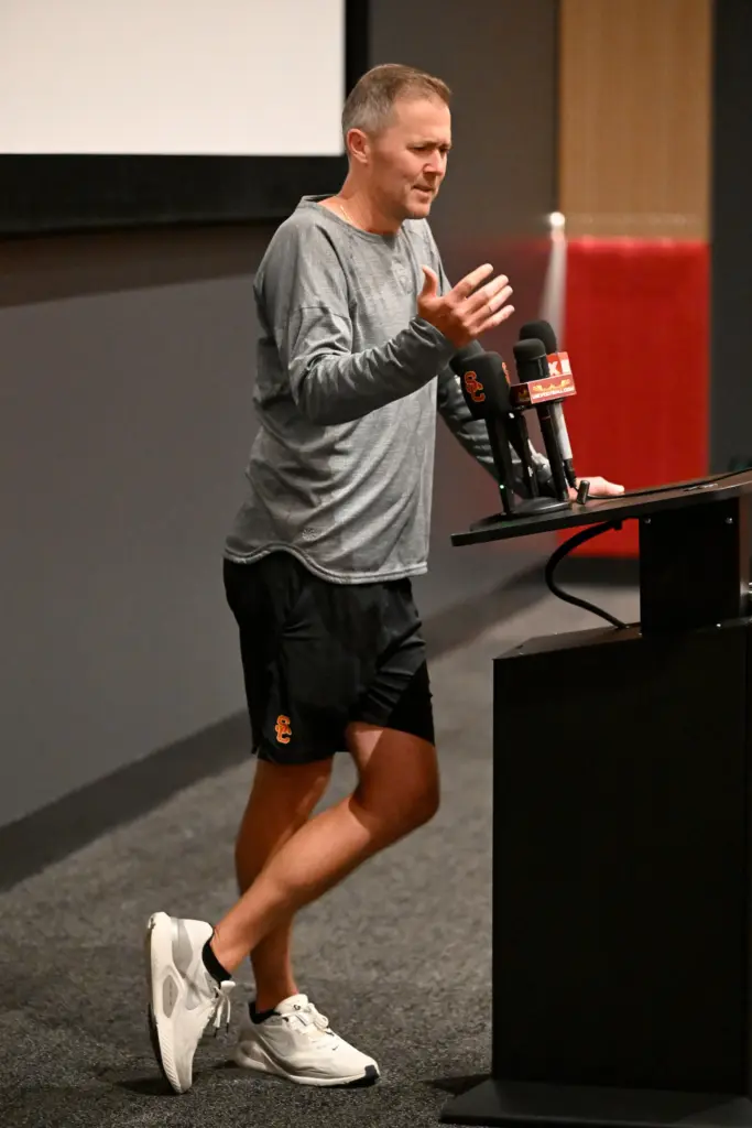 Coach Lincoln Riley talks to the media as part of...