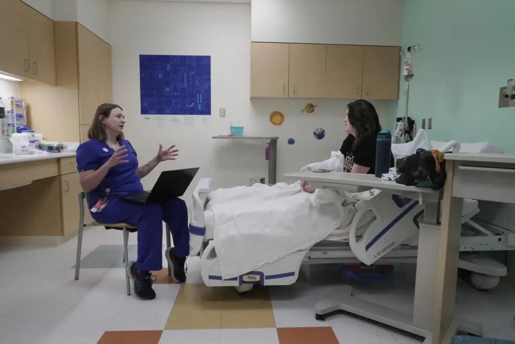Dr. Melanie Cree explains medical results to Noelani Schulmeister in...