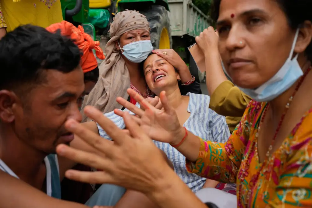 Relatives console Muna Khadka who lost her son Aayush Khada in flash floods