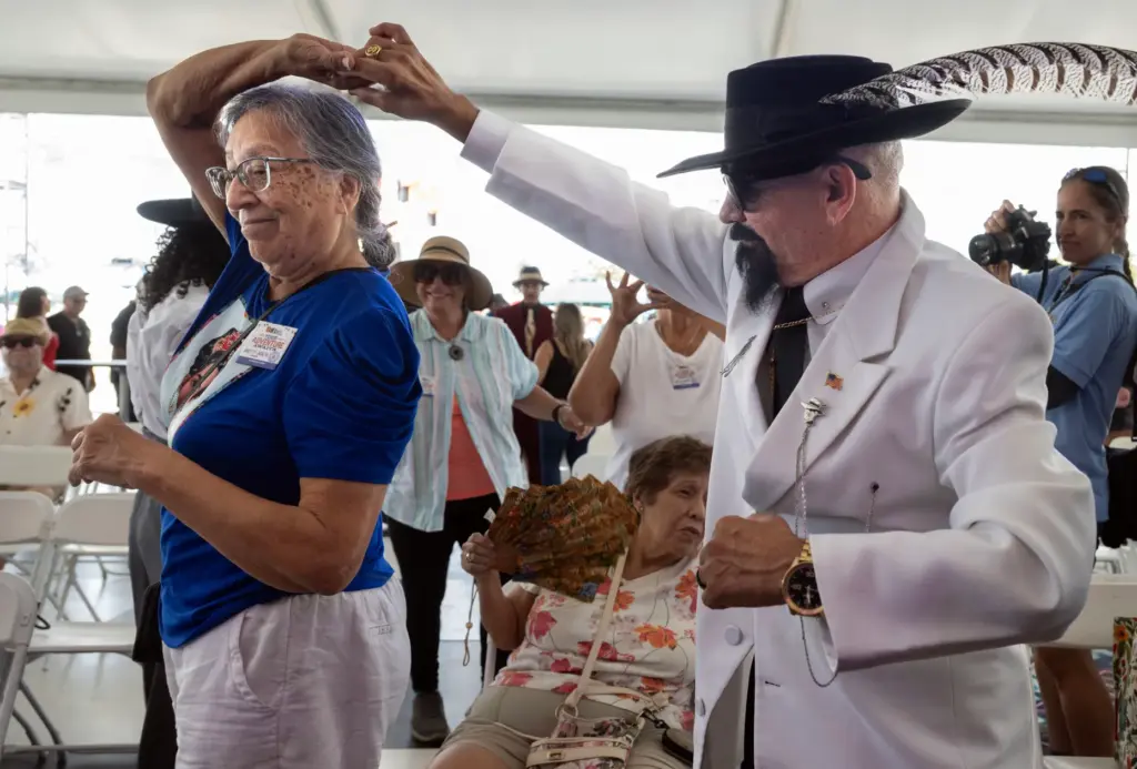Ernie Gonzalez dances with Amy De Los Reyes following the...