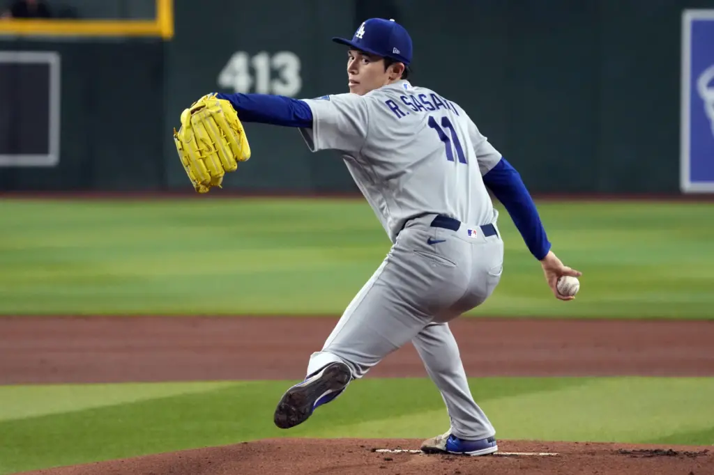 Dodgers starting pitcher Roki Sasaki throws to the plate during...