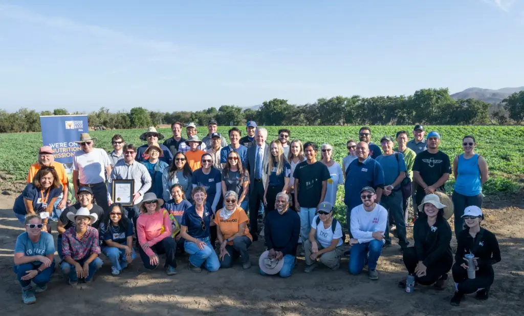 Staff and volunteers take a group photo at the Harvest...