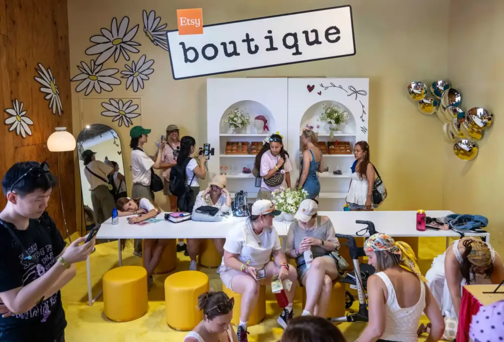 Festivalgoers visit the Etsy Boutique during the Daisy Chain Fields...