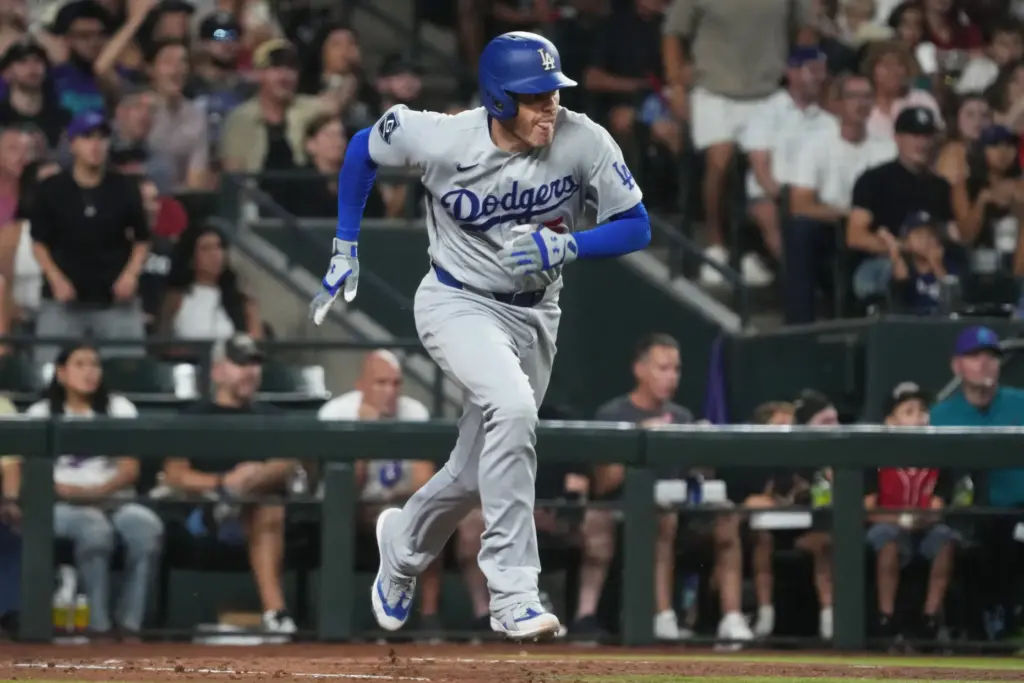 The Dodgers’ Freddie Freeman begins to run after putting the...