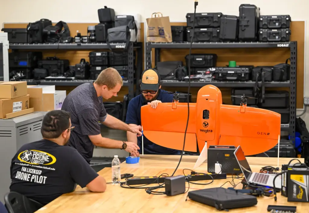 Matthew Alayoubi, left, Nicholas Stafford, center, and Blake Castillo, work...