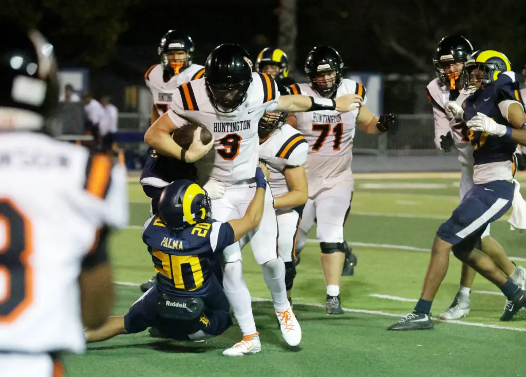 Millikans Matteo Palma (20) tries to take down Huntington Beachs...