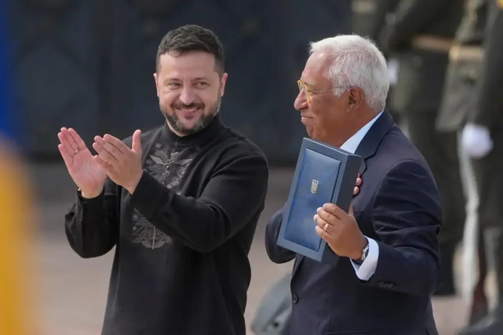 Ukraine's President Volodymyr Zelenskyy hands over the Ukraine state award to European Council President Antonio Costa.