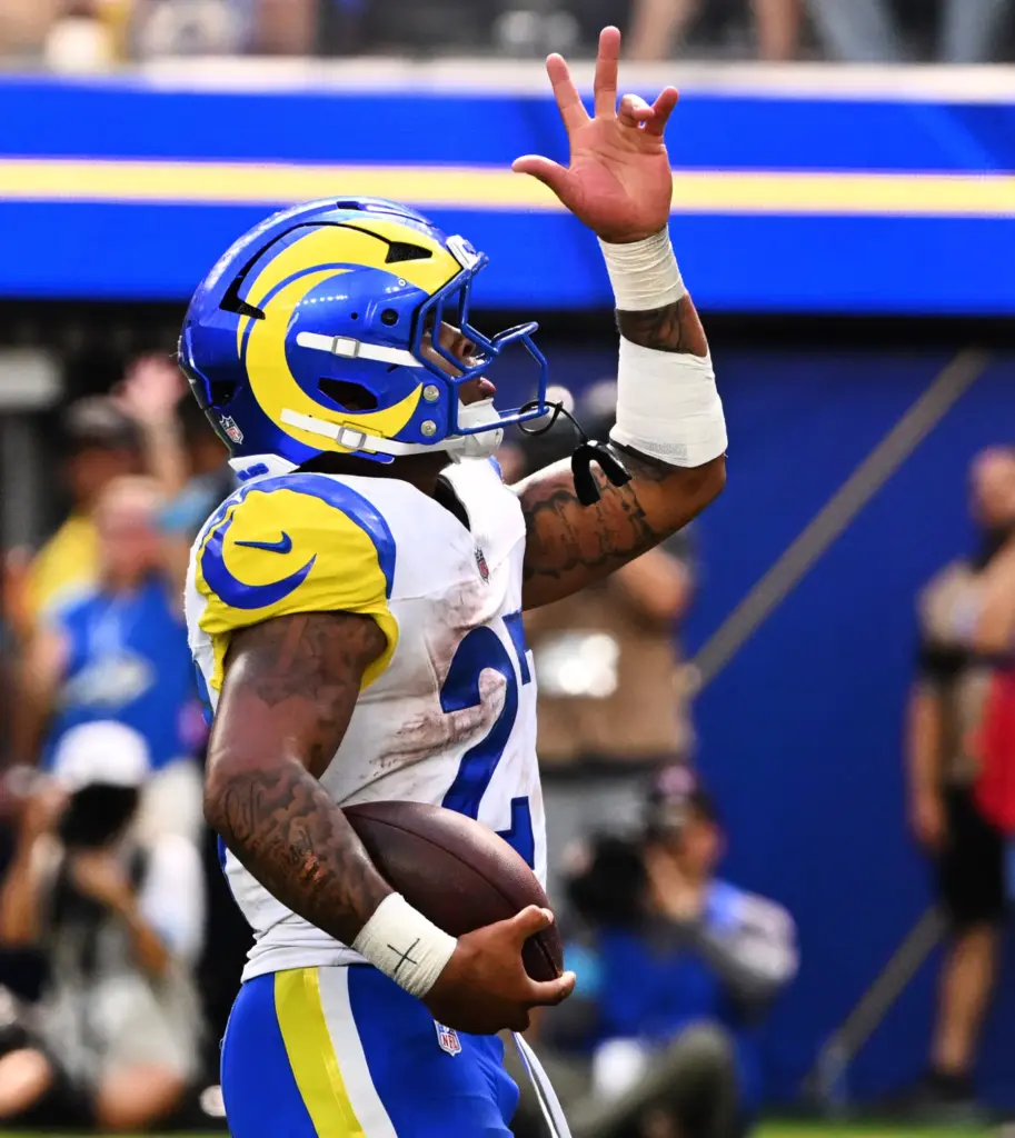 Rams running back Jarquez Hunter (27) reacts after running for...