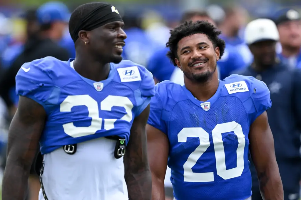 Rams running backs Jordan Waters, left, and Ronnie Rivers look...