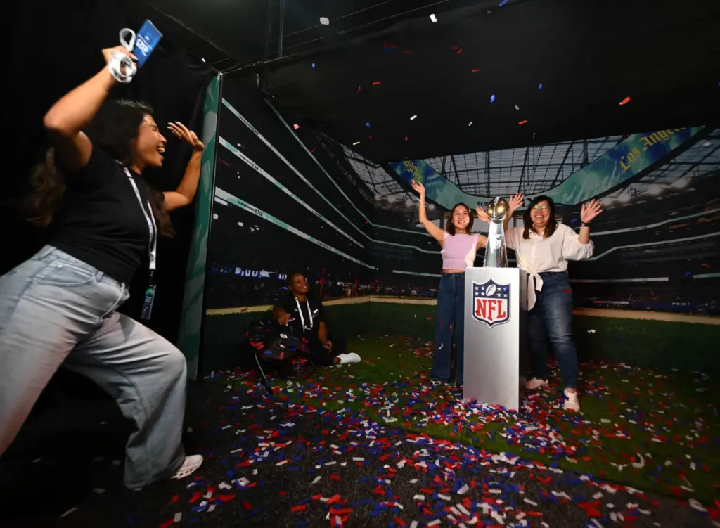 Stef Quek and Jeslyn Chong cheer with the Lombardi trophy...