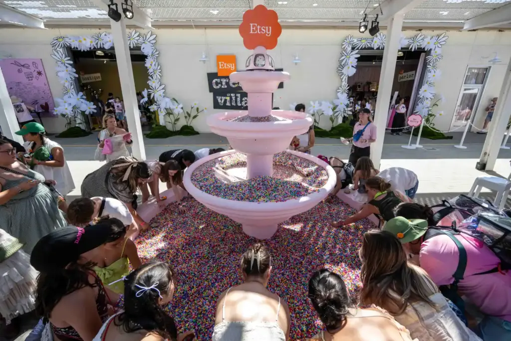 Festivalgoers visit the Etsy bead fountain during the Daisy Chain...
