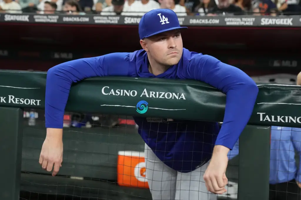 Dodgers pitcher Tarik Skubal watches from the dugout during a...