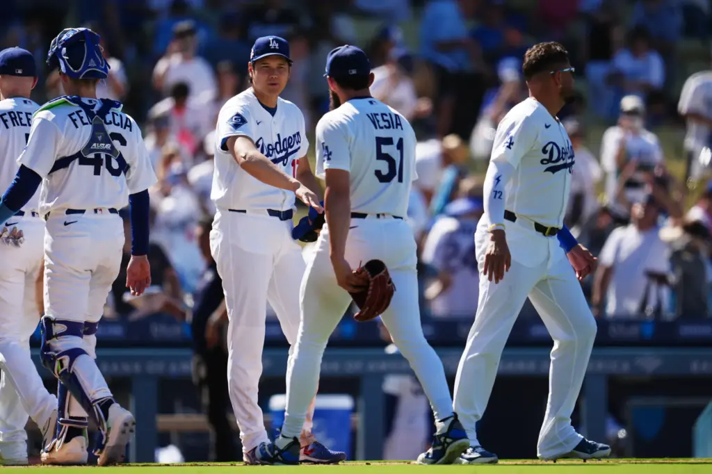 Dodgers’ Shohei Ohtani, center, congratulates pitcher Alex Vesia after defeating...