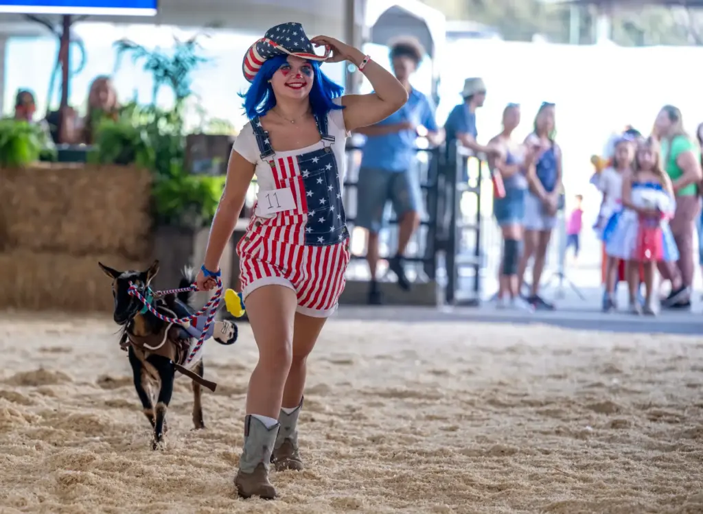 Macy Ford of Huntington Beach walks with her goat, Willie,...