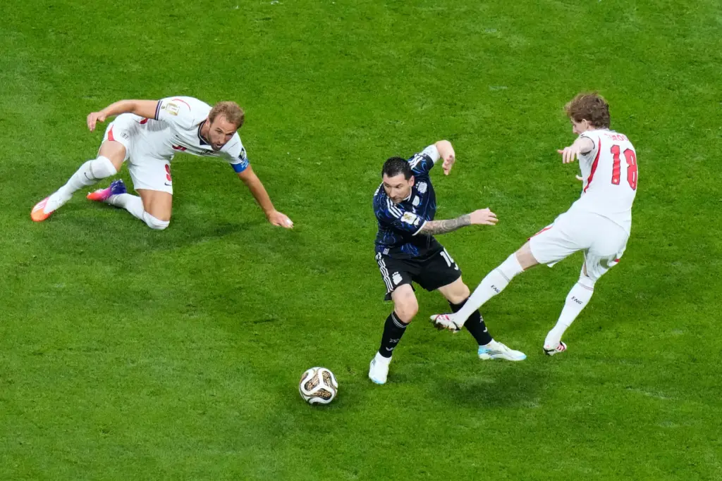 FILE – Argentina’s Lionel Messi (10) dribbles between England’s Anthony...