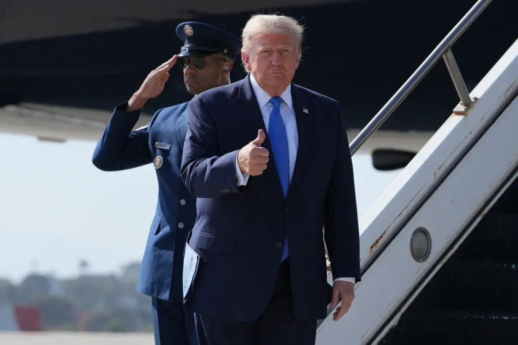 President Donald Trump arrives on Air Force One, Tuesday, Aug....