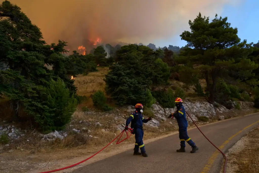 Firefighters operate on Mount Kithairon near Porto Germeno, northwest of Athens, Greece.