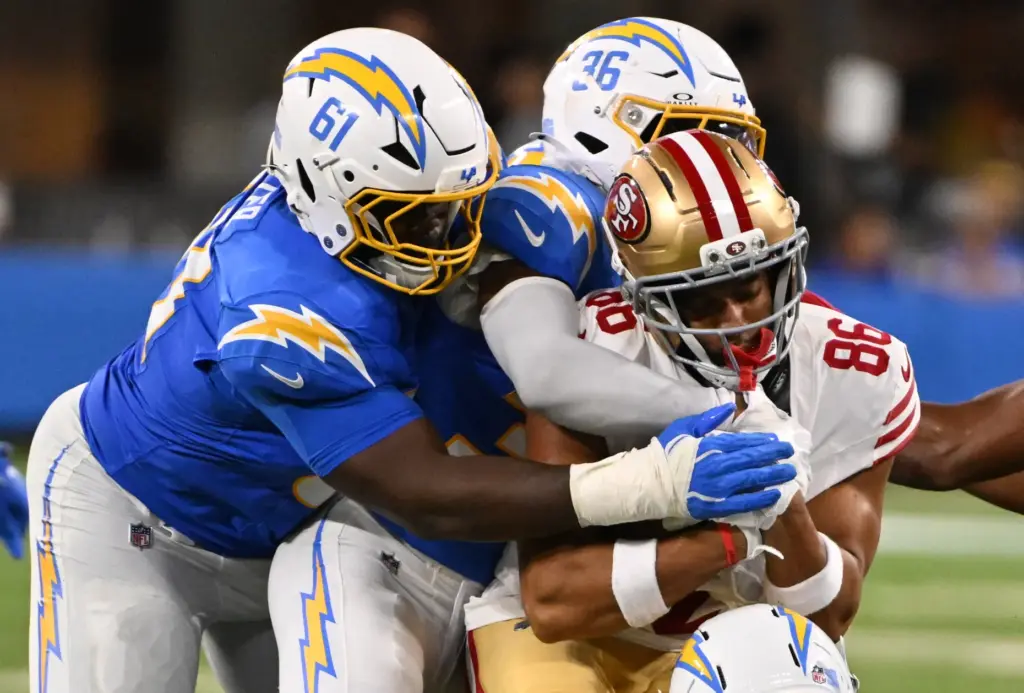 Chargers defensive tackle Jahmeer Carter, left, and cornerback Avery Smith...
