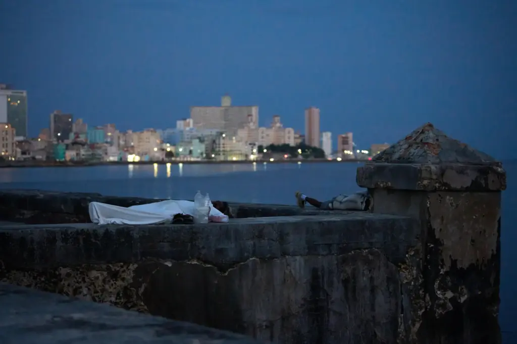 People sleep on the MalecÃ³n seawall to escape the heat of their homes in Havana.
