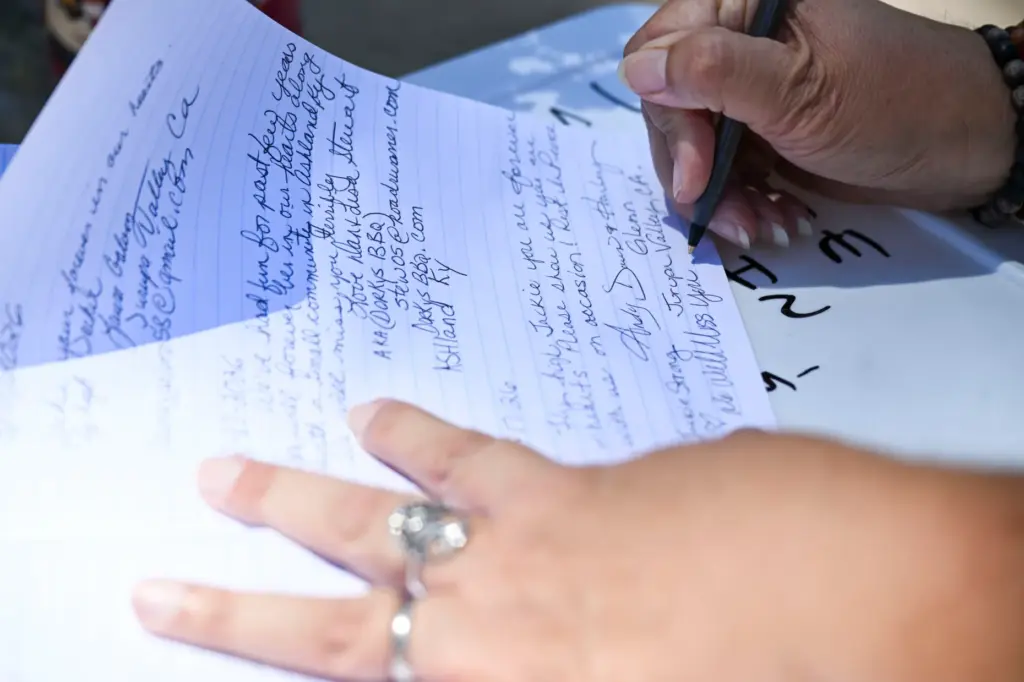 Dawn Manginen-Glenn leaves a note in the guestbook at the...