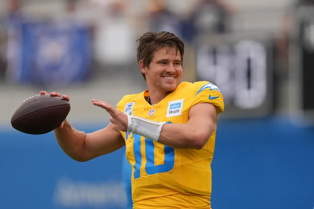 Chargers quarterback Justin Herbert throws during an NFL football training...