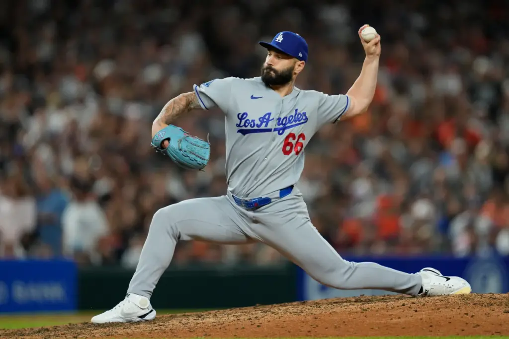 Dodgers relief pitcher Tanner Scott throws to the plate against...
