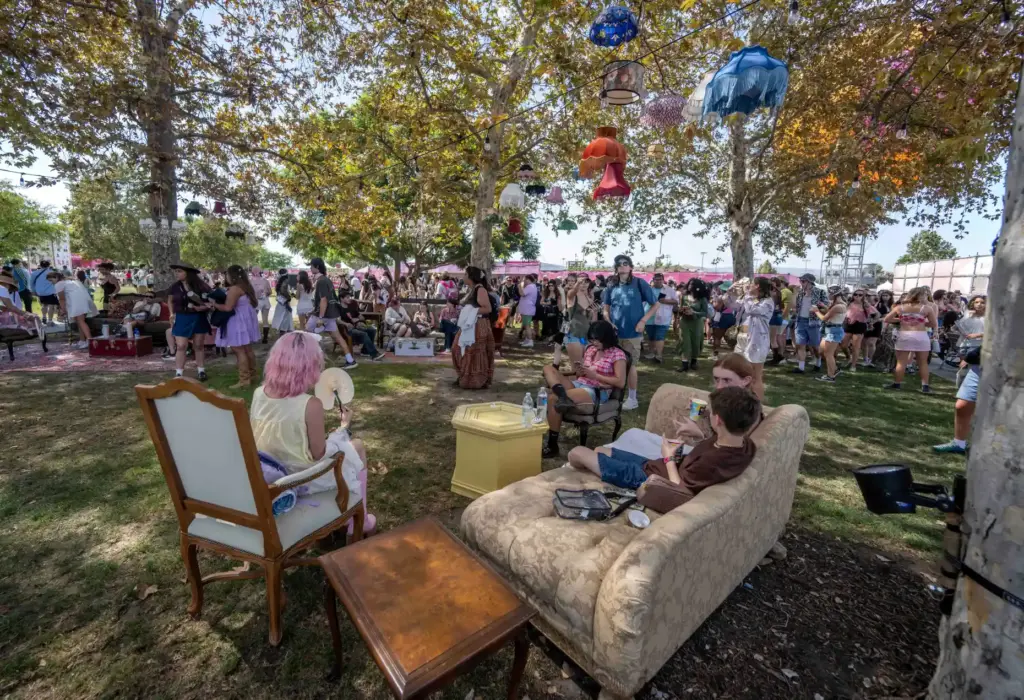 Festivalgoers lounge on furniture on the lawn at the Great...