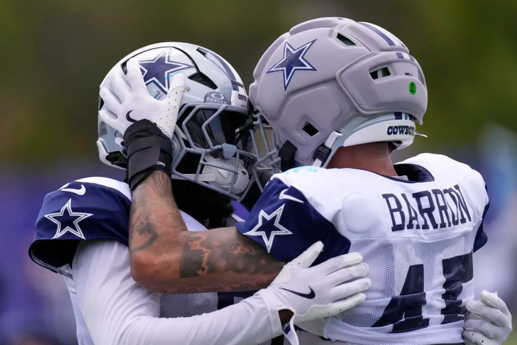 Dallas Cowboys linebacker Justin Barron, right, celebrates with linebacker Demarvion...